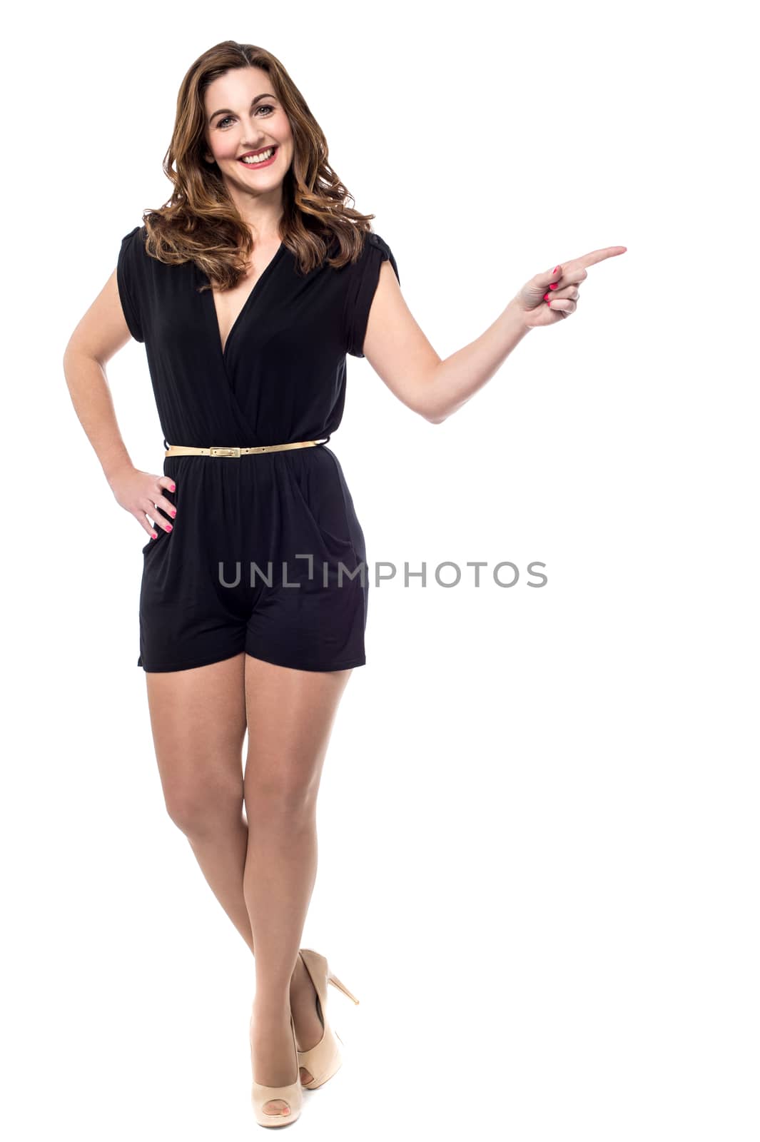 Trendy smiling woman pointing at copy space