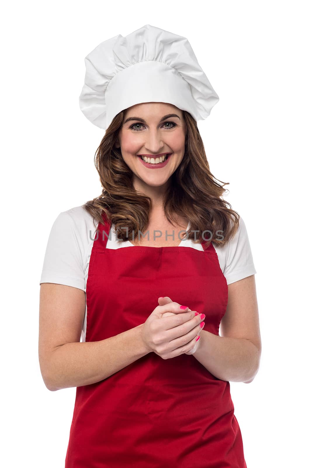 Happy female chef posing with hands clasped