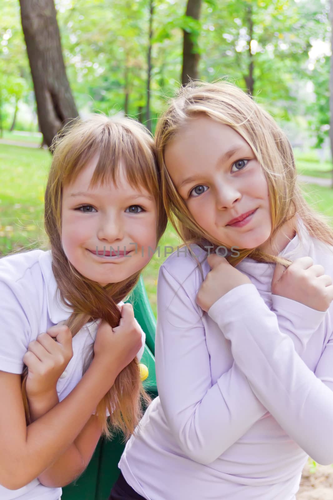 Photo of two playing girls in summer