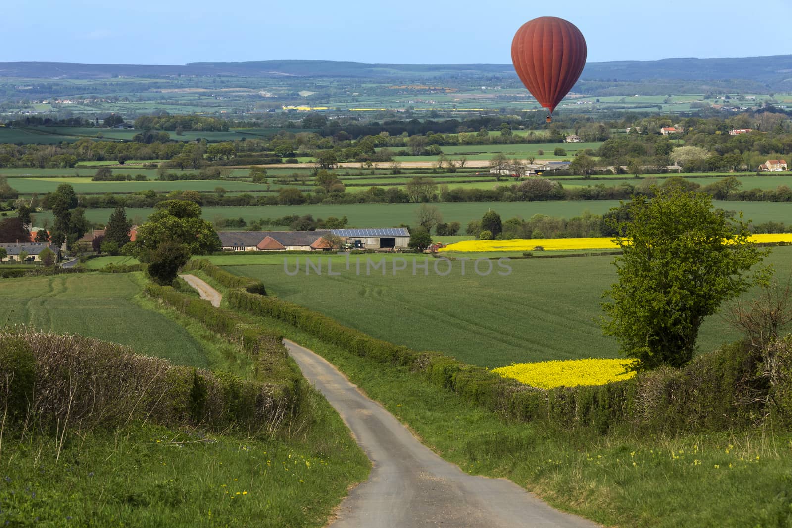 Hot air balloon drifting over the Harwardian Hills in North Yorkshire in the northeast of England.