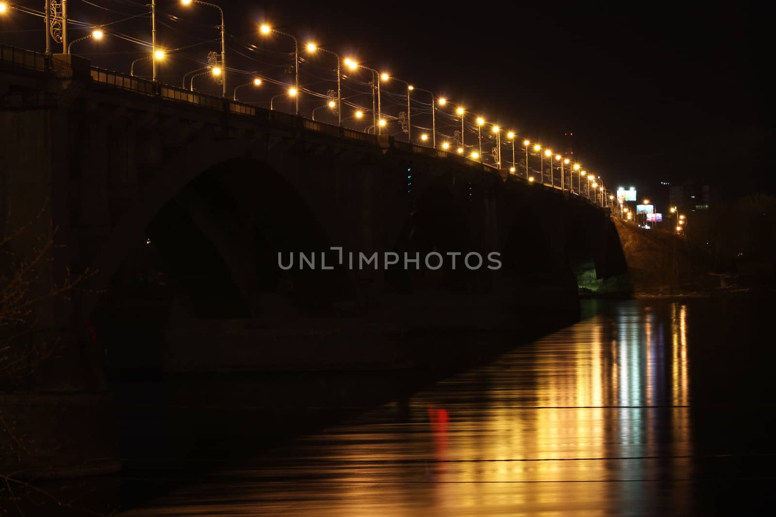 Road bridge over the river at night