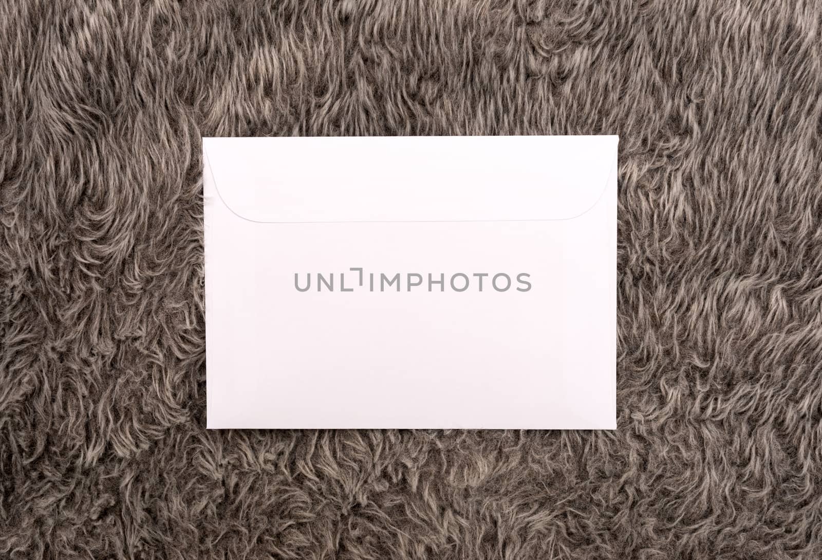 white envelope on a fur background by DNKSTUDIO