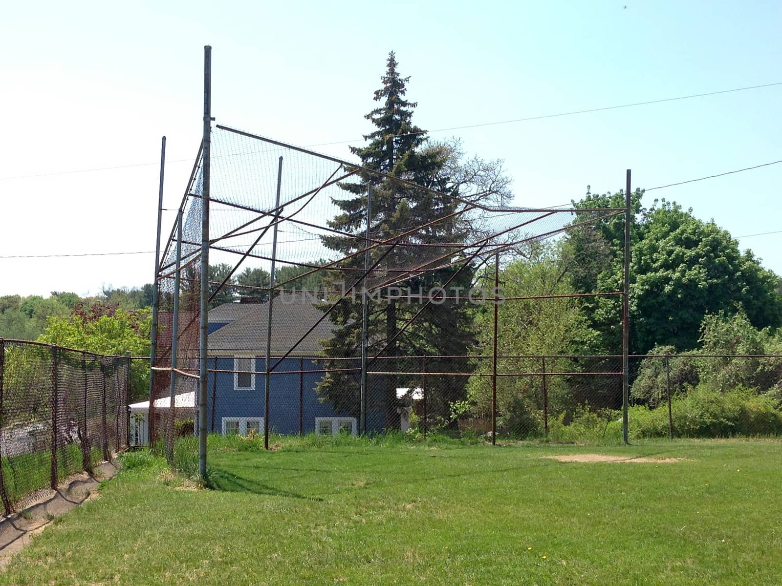 Baseball field and backstop in the suburb.
