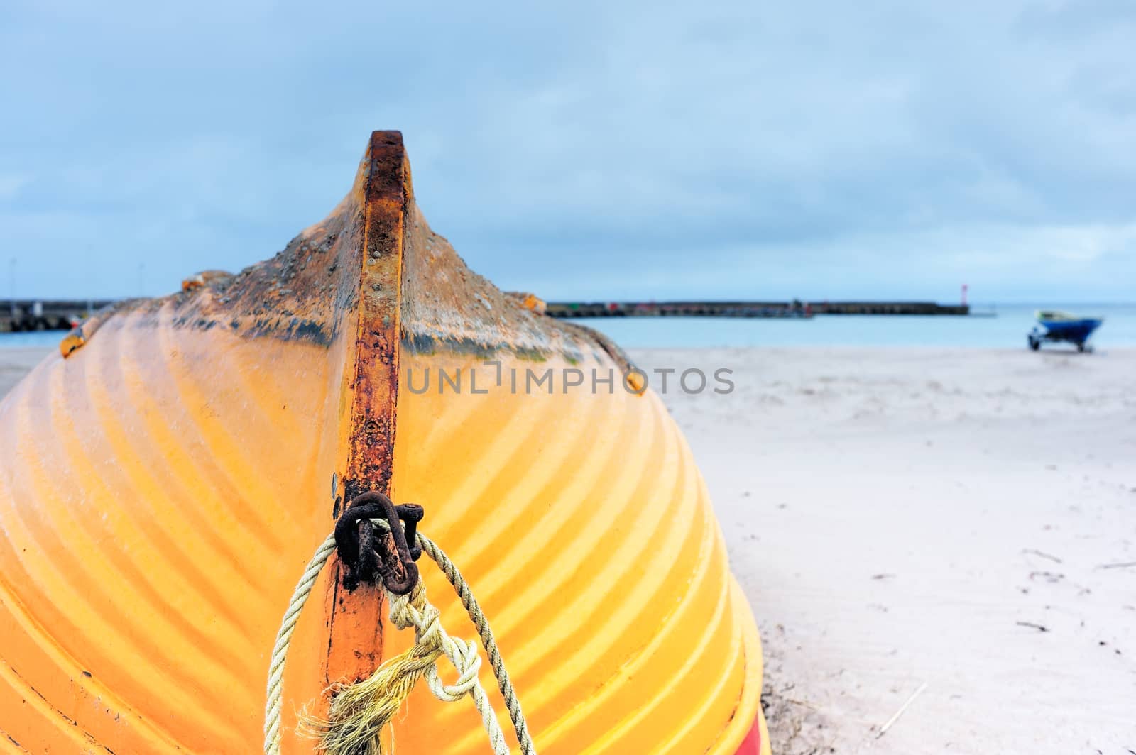 Wooden boat inverted bottom up on the sandy beach