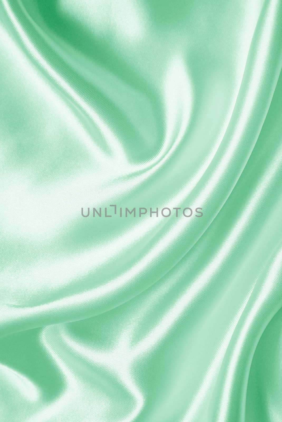Smooth elegant green silk or satin texture as background 