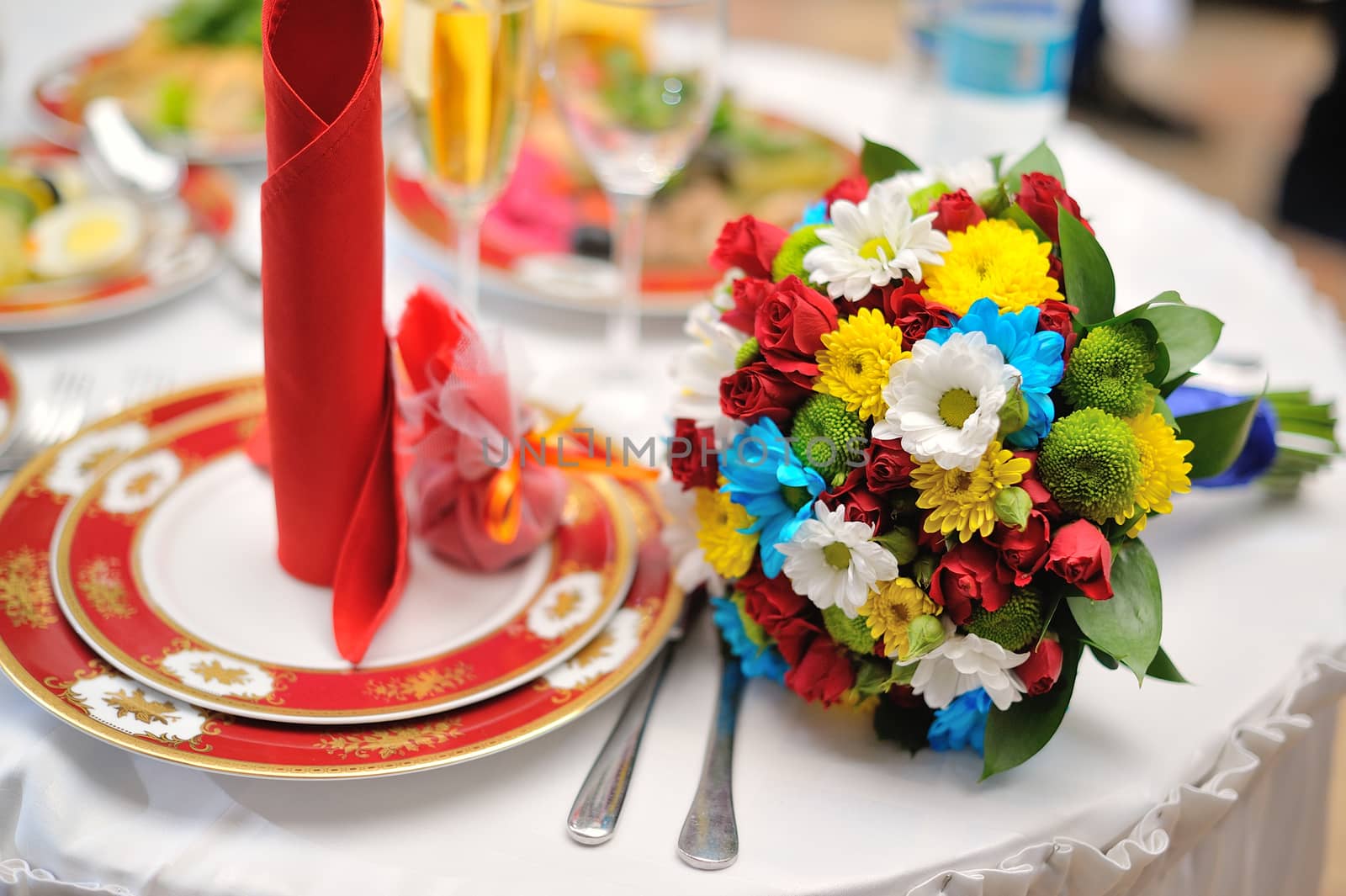Colorful wedding bouquet lying on table in restaurant