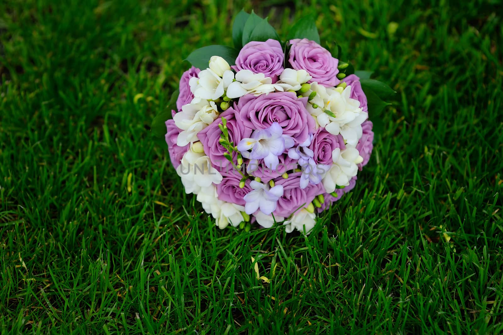 pink and white wedding bouquet on grass