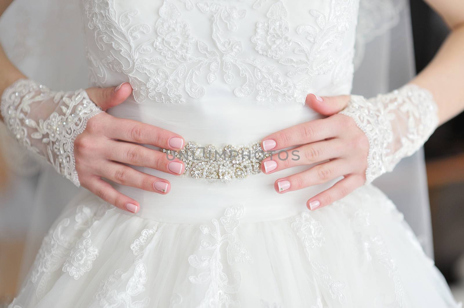 Hands bride with a manicure, on the finger of the bride wedding.