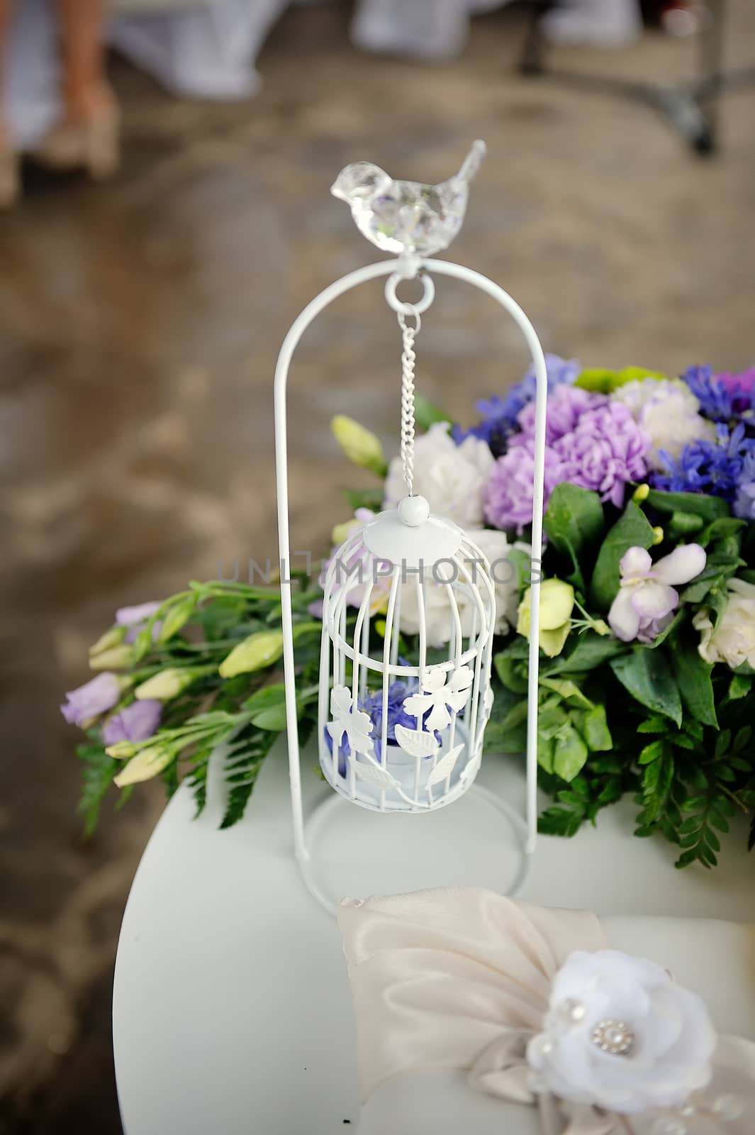 Wedding decor, white with a bird cage in restaurant