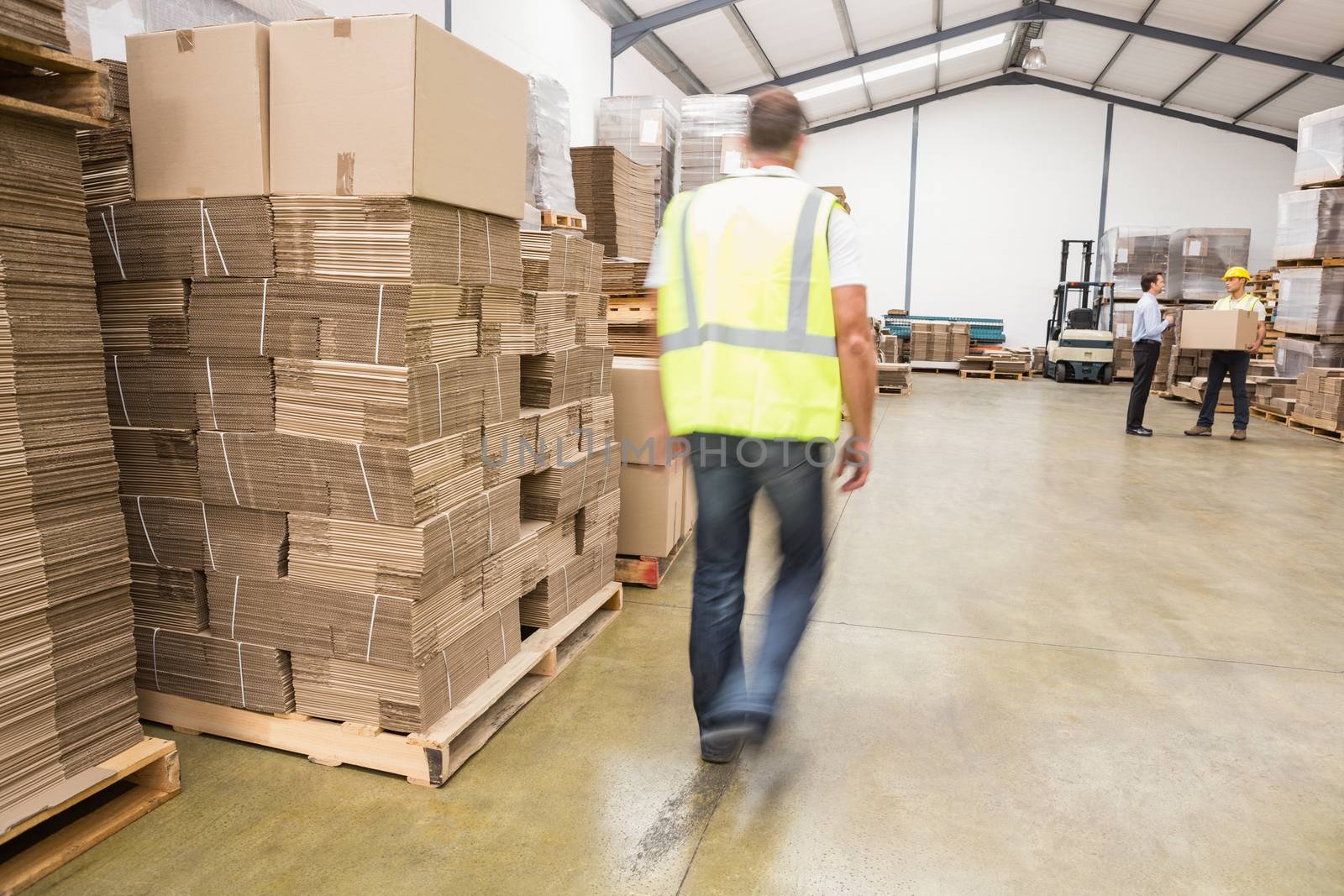 Blurred manual worker walking in the warehouse