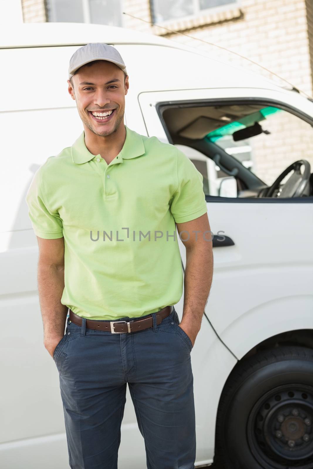Smiling man in front of delivery van by Wavebreakmedia