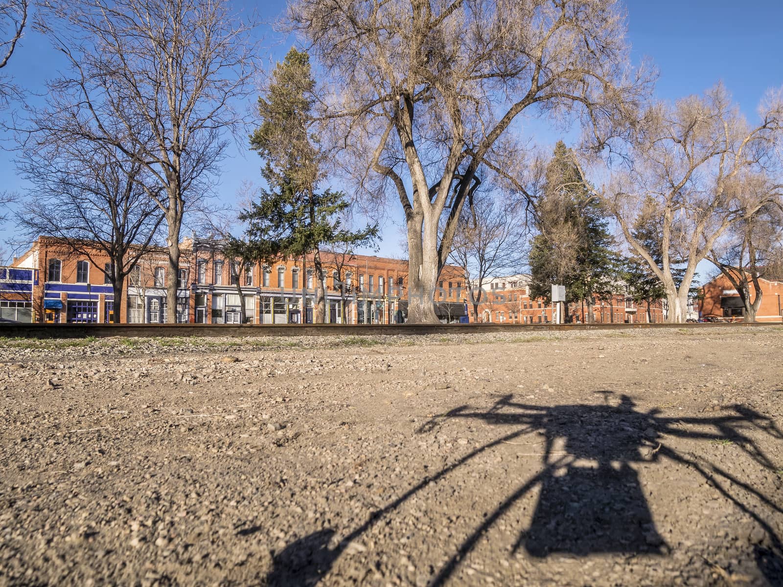 A shadow of quadcopter drone with camera taking off to fly over city