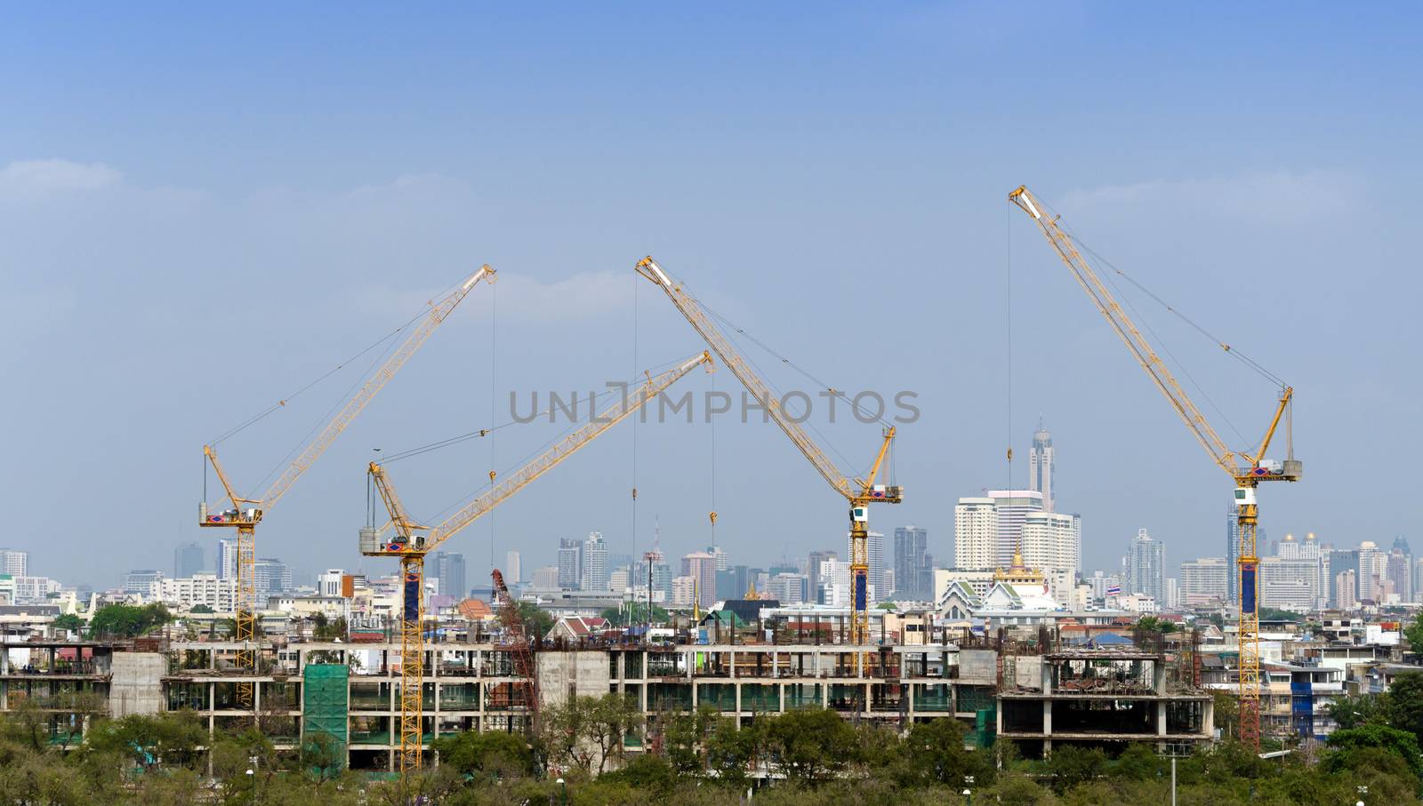 Building and cranes under construction