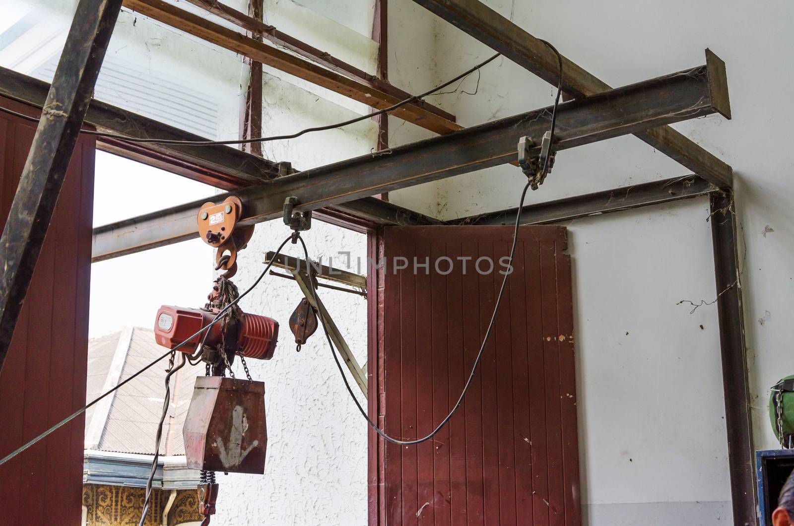 Abandoned rusty crane with pulley