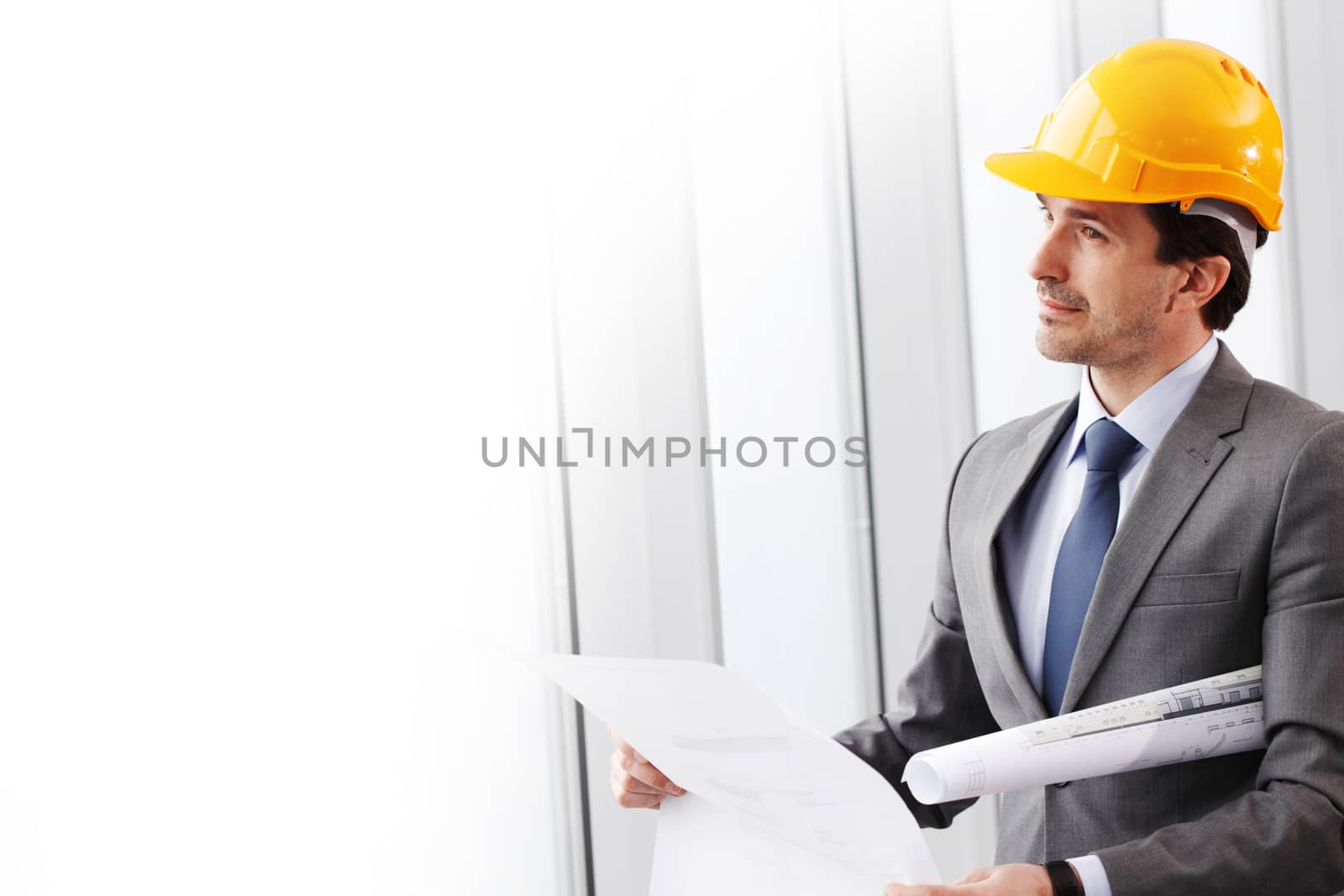 businessman in construction helmet thinking