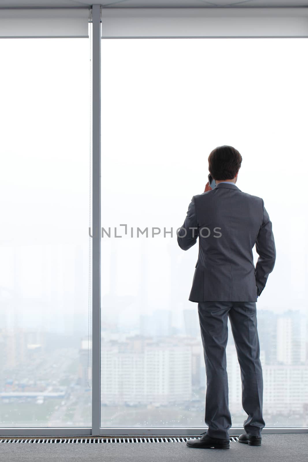 businessman with mobile phone by ALotOfPeople