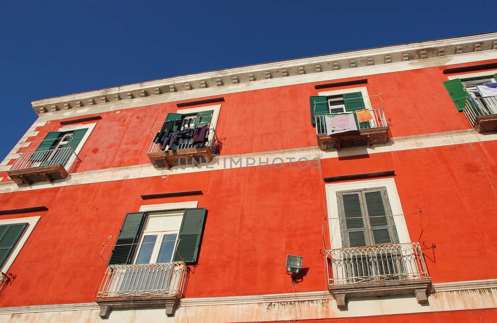 Italy. Campania region. Procida island. Mediterranean orange ochre house facade 