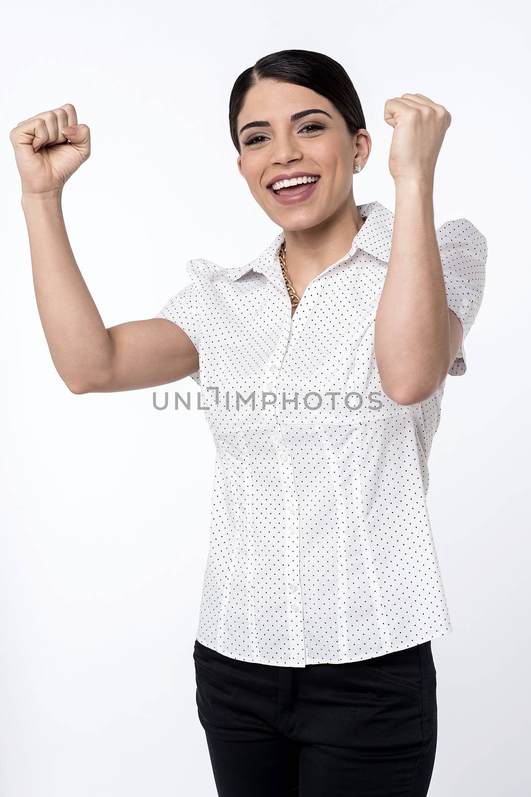 Happy woman celebrating with arms up joy of winning