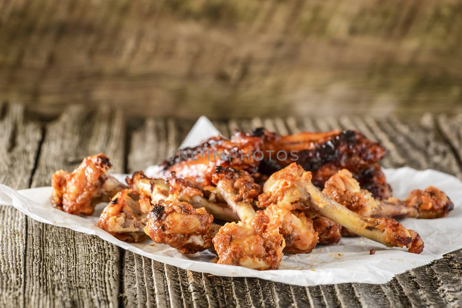 Pile of bones from already eaten barbecued chicken wings.