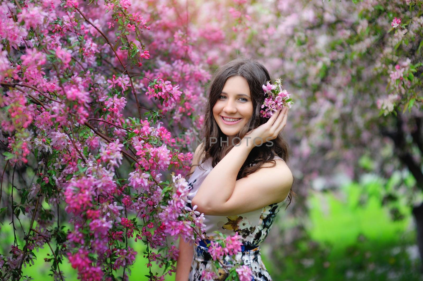 Beautiful smiling girl in a spring garden.