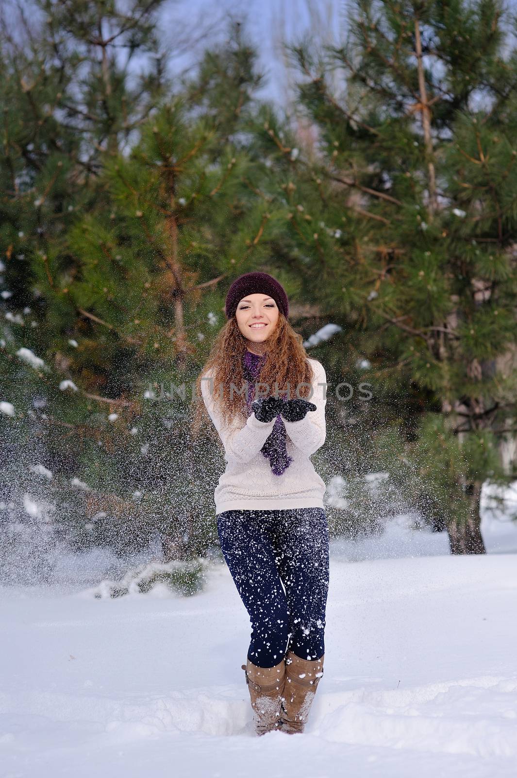 girl standing on background winter trees in park