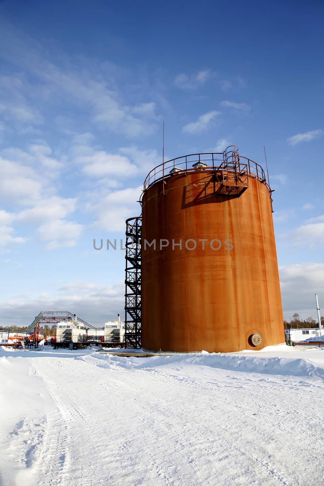 Tank storage crude Oil in winter landscape