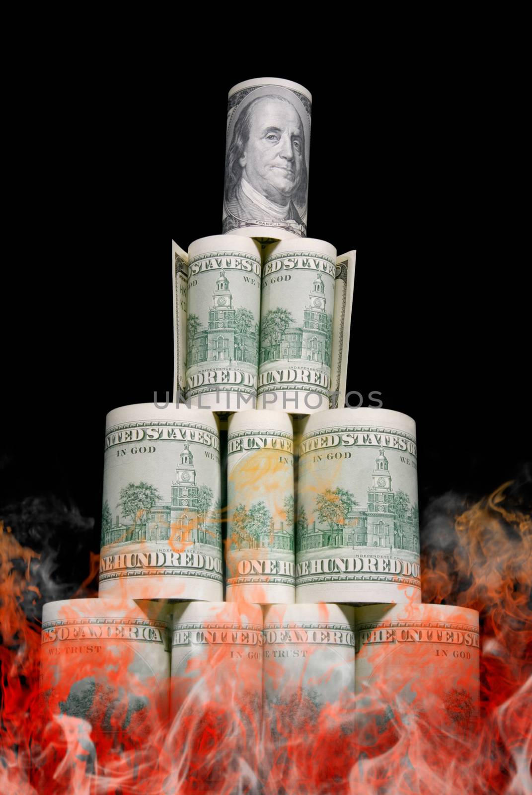 Dollar pyramid on a black background. Money burn.