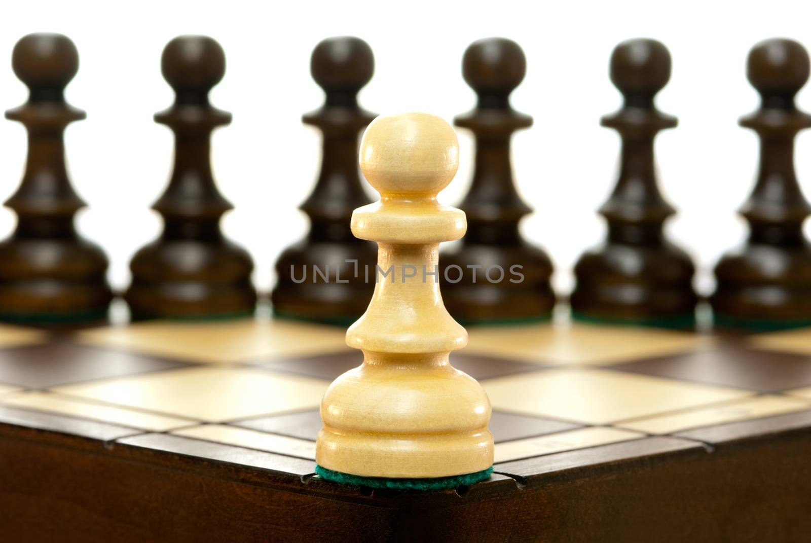 It is a lot of chessmen on a chess board. (are located it is horizontal). A white background.