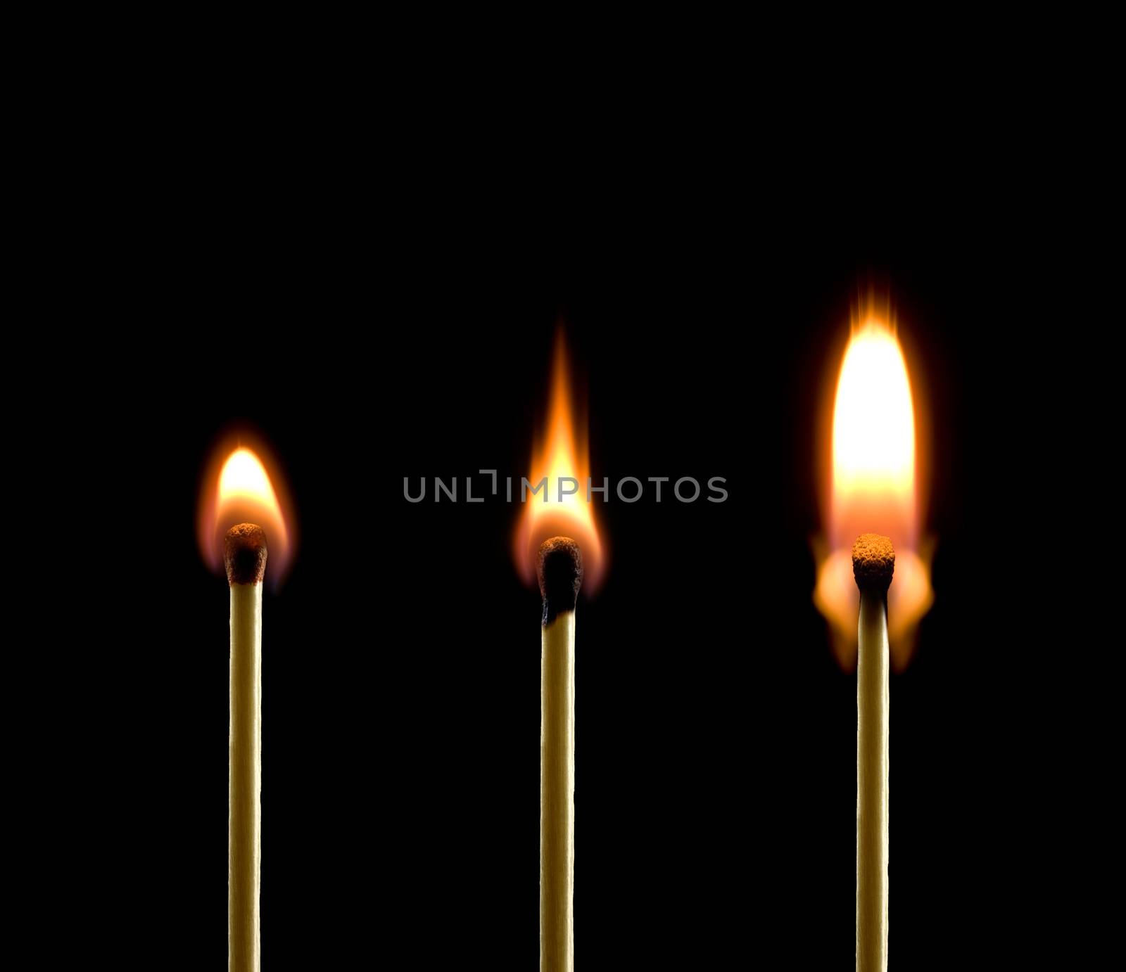 Three matches on a black background. Beautiful fire.