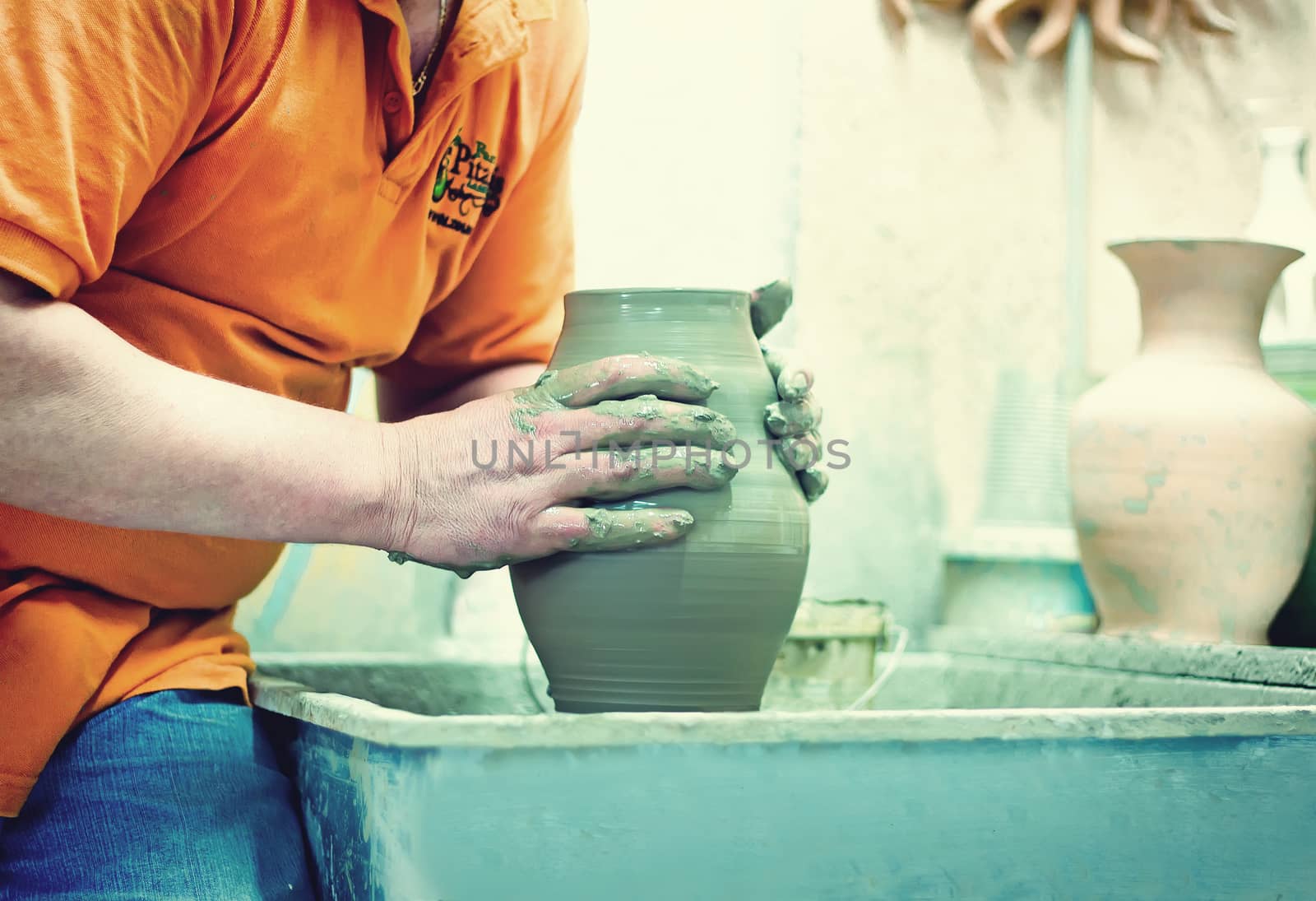 People at work: the production of ceramic vases on a Potter's wh by georgina198