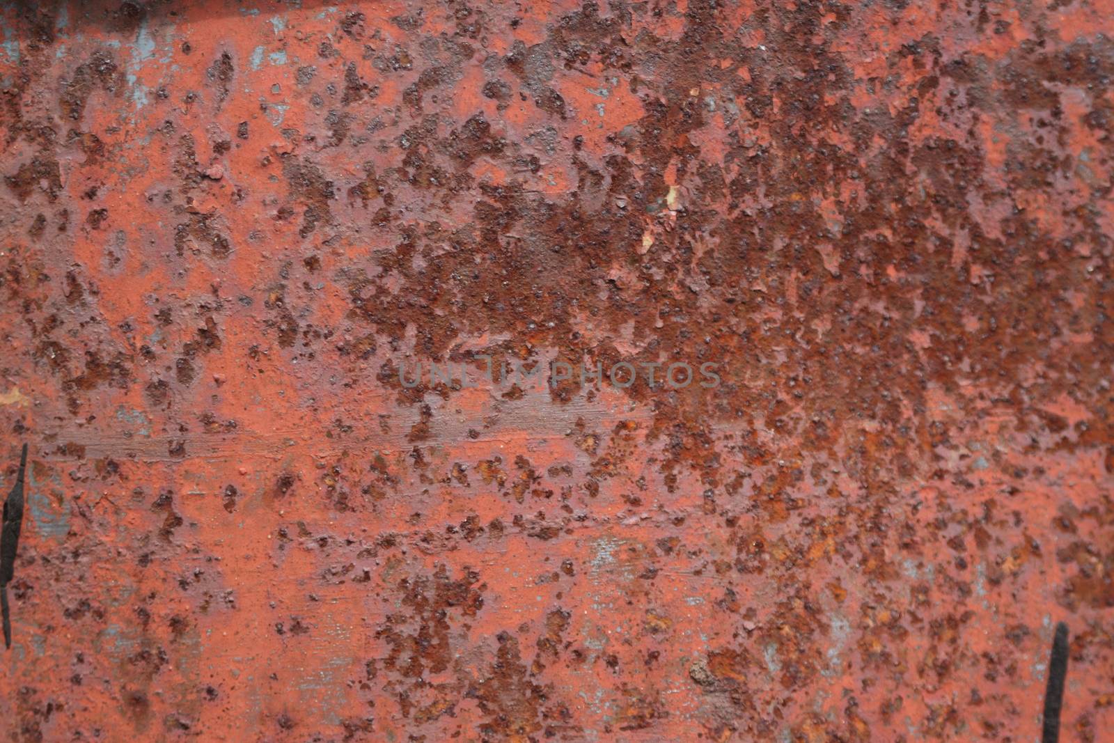 scratched and rusty orange metal surface as background