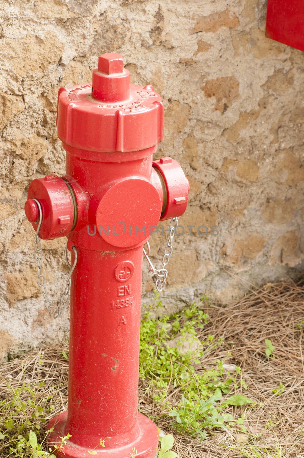 red hydrant construction in a park for the safety of persons