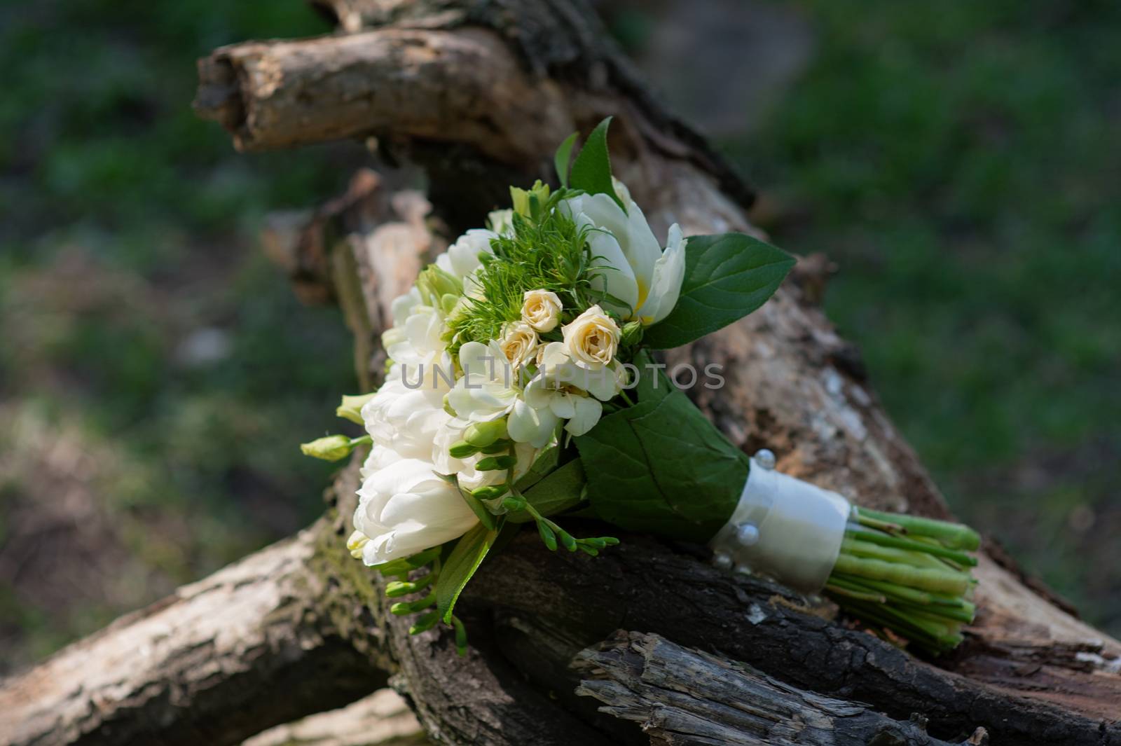 bridal bouquet lying on the swing in park