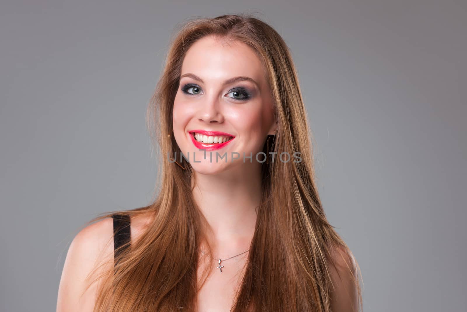 beautiful happy smiling teen girl over gray background