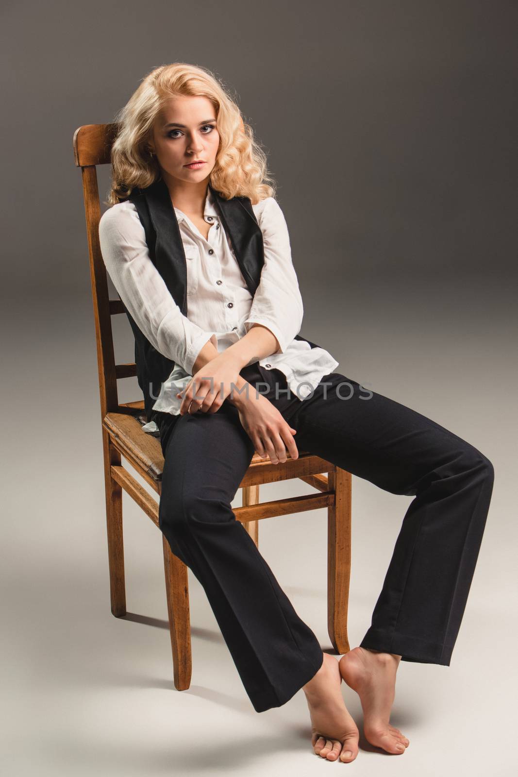 Beauty blond woman on chair by master1305