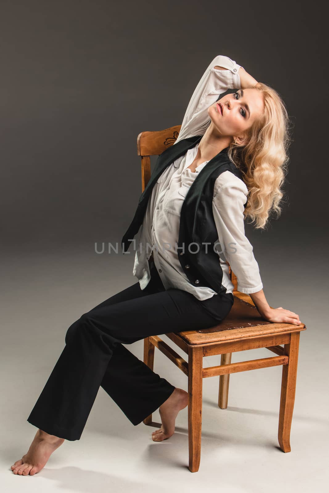 Beauty blond woman on chair by master1305