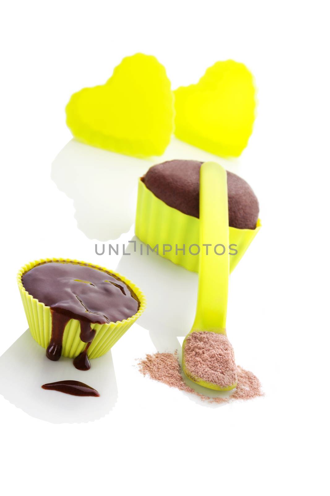 Cupcake chocolate mixture in neon green colored baking forms isolated on white background. Culinary cupcakes baking.