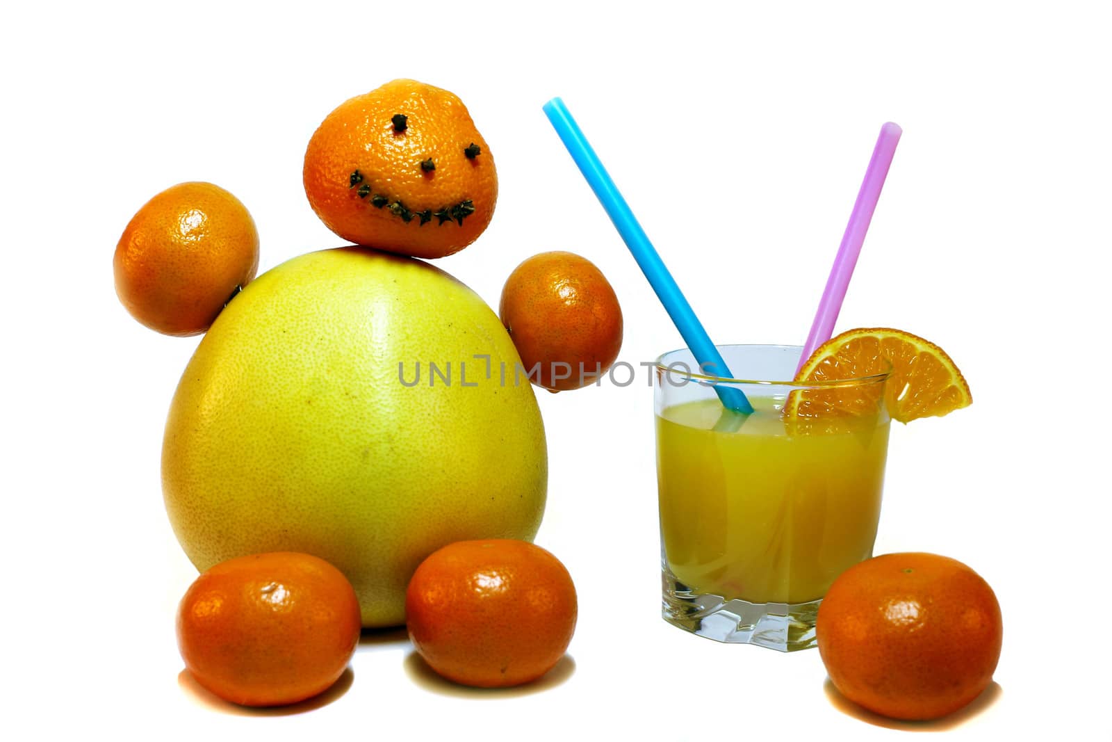 Citrus fruits stacked in the form of a funny little man with a glass of orange juice