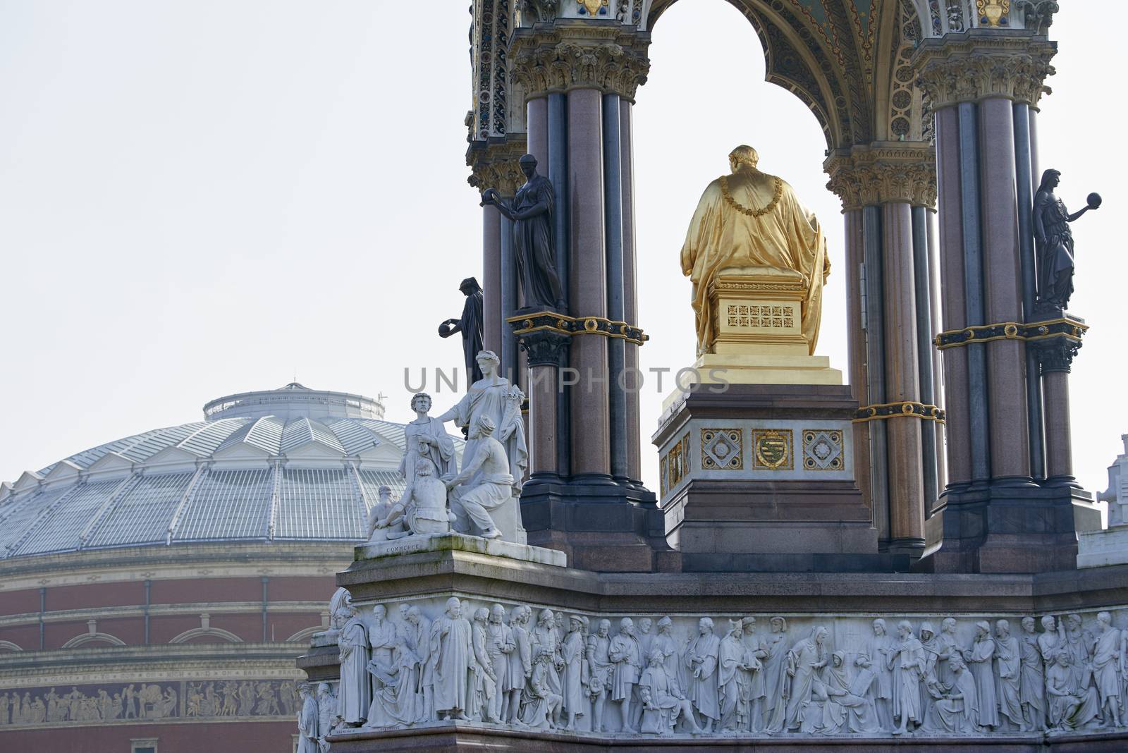 Albert Memorial statue overlooking hazy Royal Albert Hall, in London. The memorial was commissioned by Queen Victoria in memory of her husband, who died in 1861.