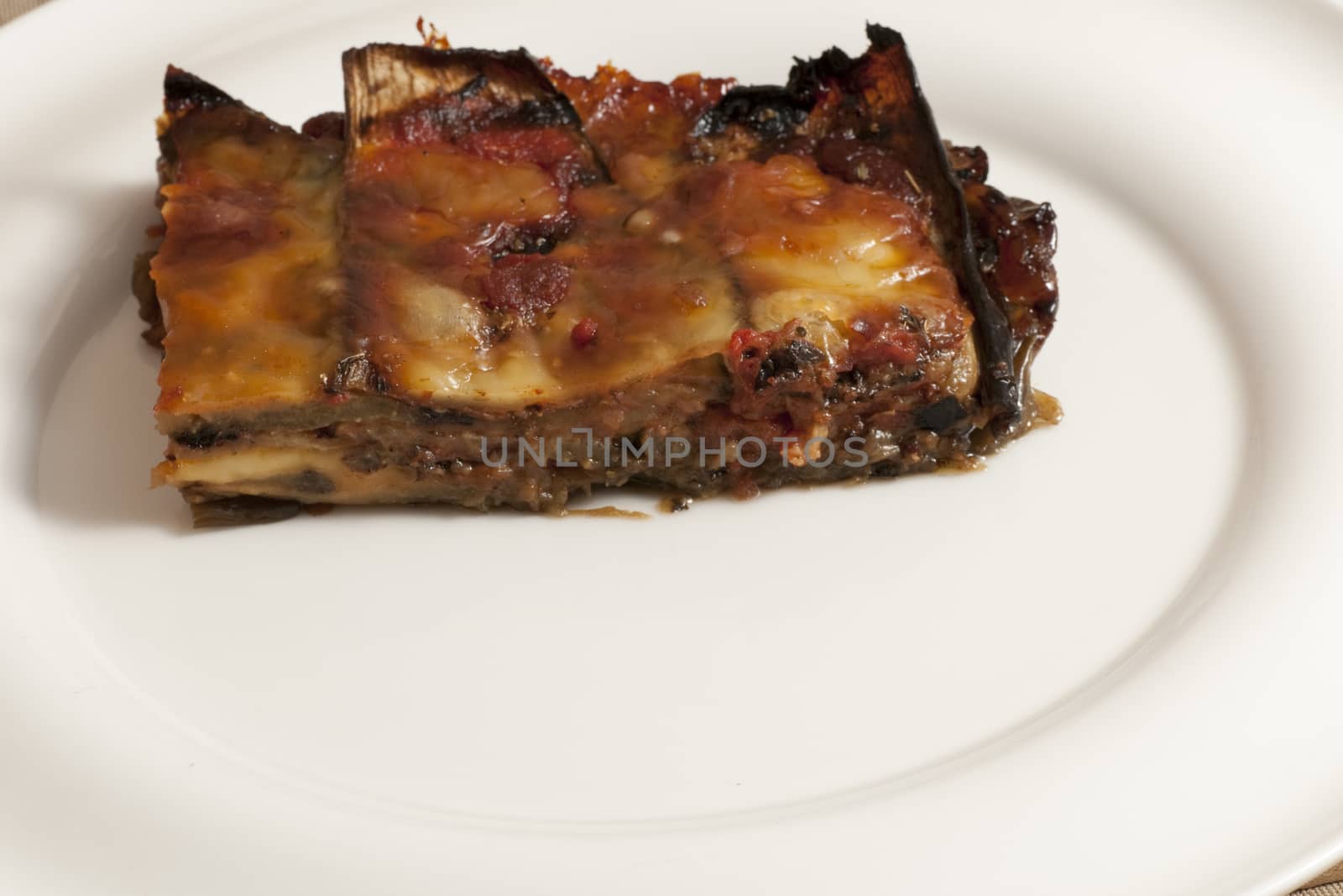 delicious eggplant parmesan served on a white plate
