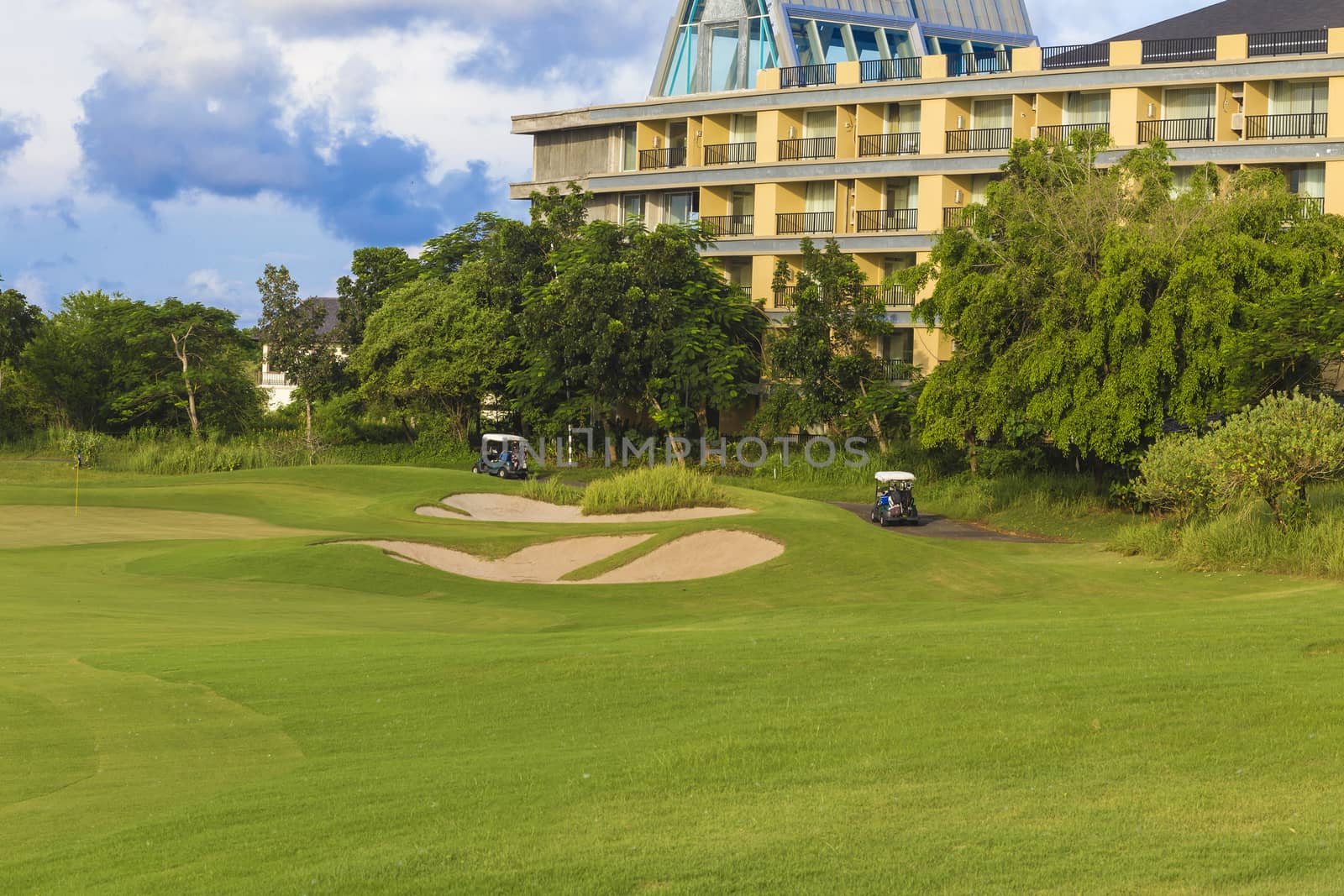 Beautiful View of Green Golf Field with Blue Sky.