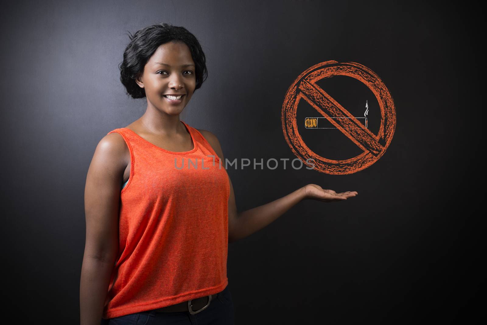 South African or African American woman teacher or student displaying a no smoking sign