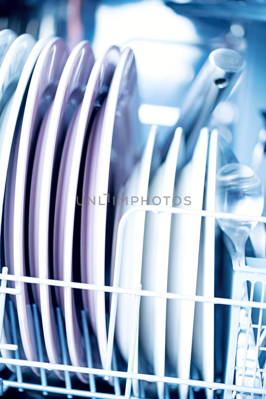 Clean kitchenware in dishwasher macro by Nanisimova