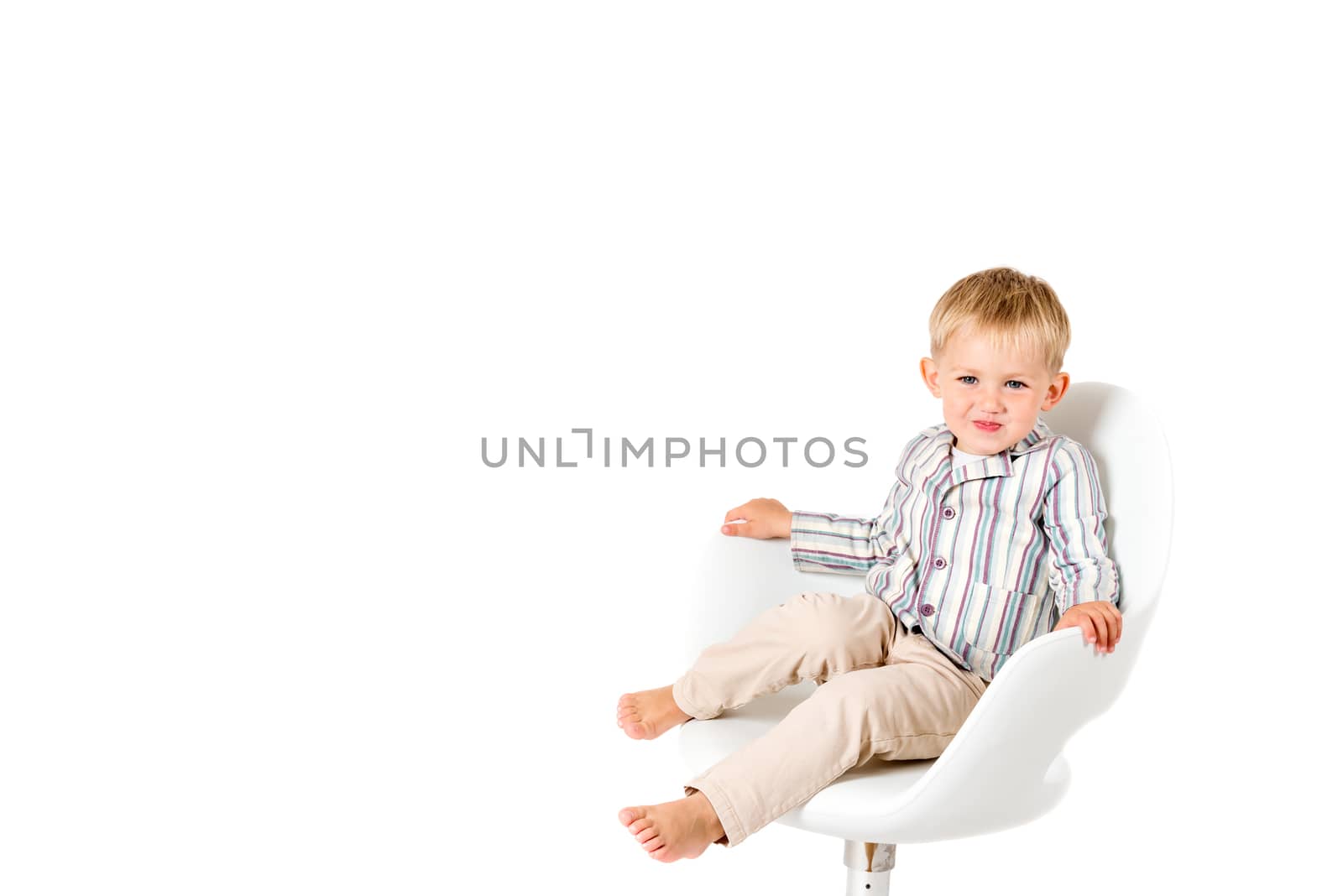 Boy shot in the studio on a white background in chair copy space by Nanisimova