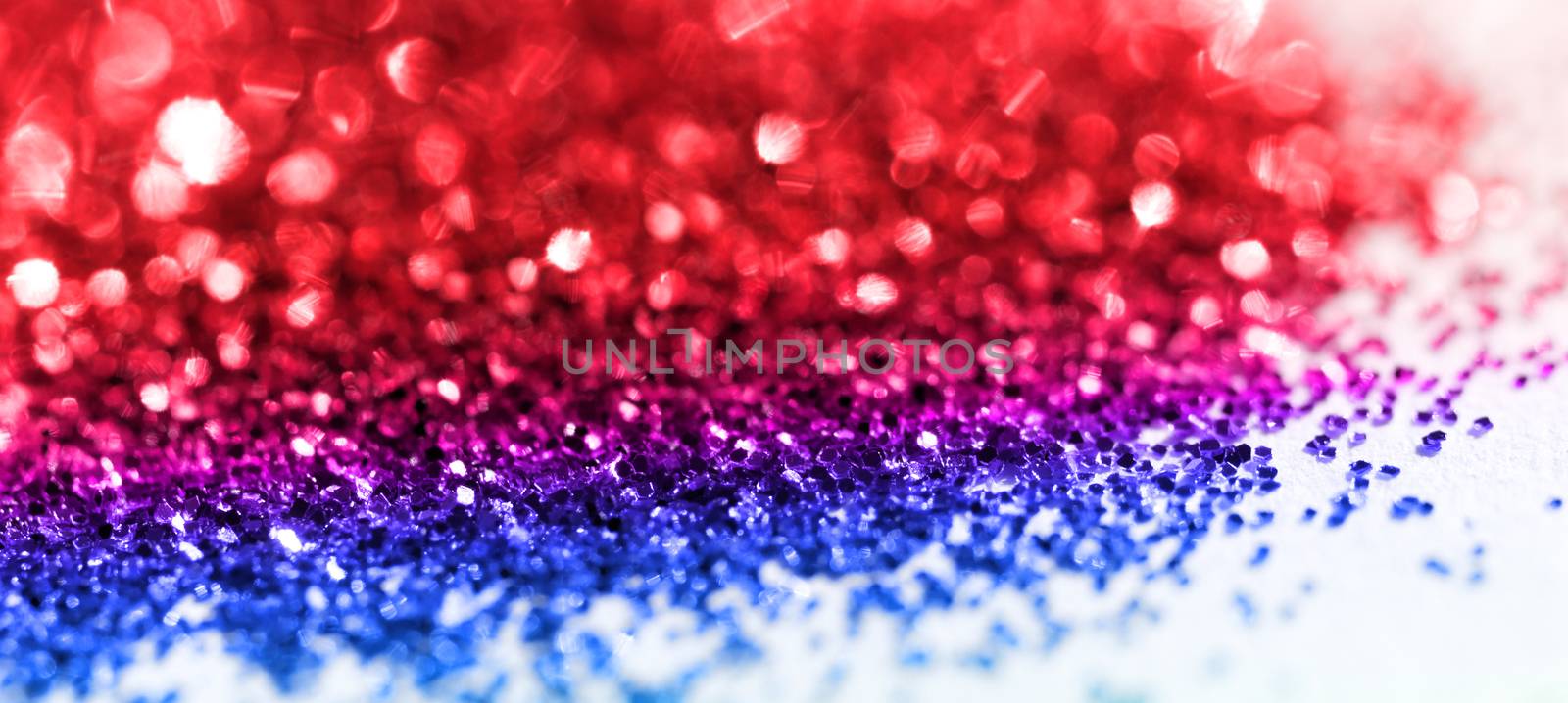 Multicolor glitter on light background - macro photo
