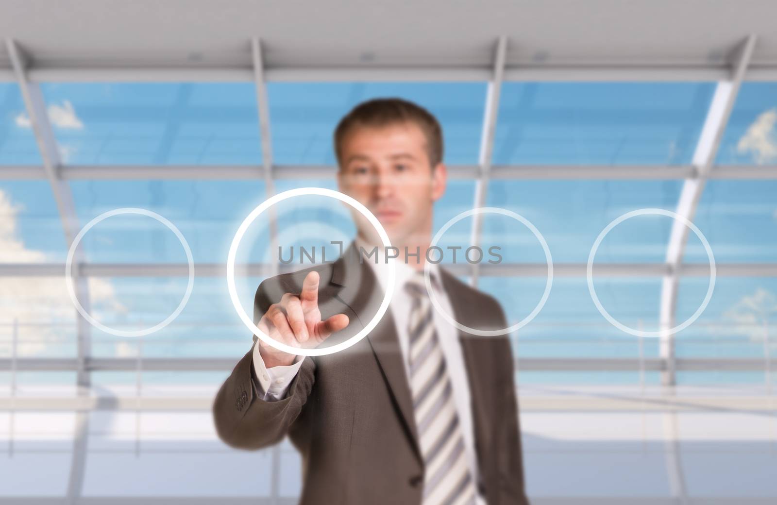 Businessman pressing on holographic screen on window background