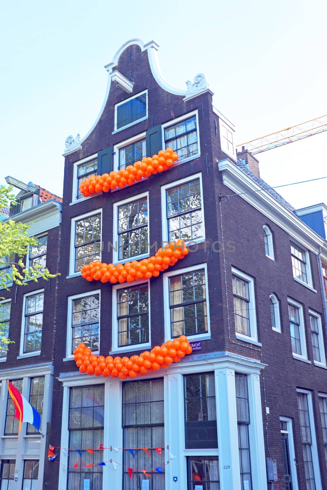Traditional dutch house decorated with flags and balloons on Kingsday in Amsterdam the Netherlands