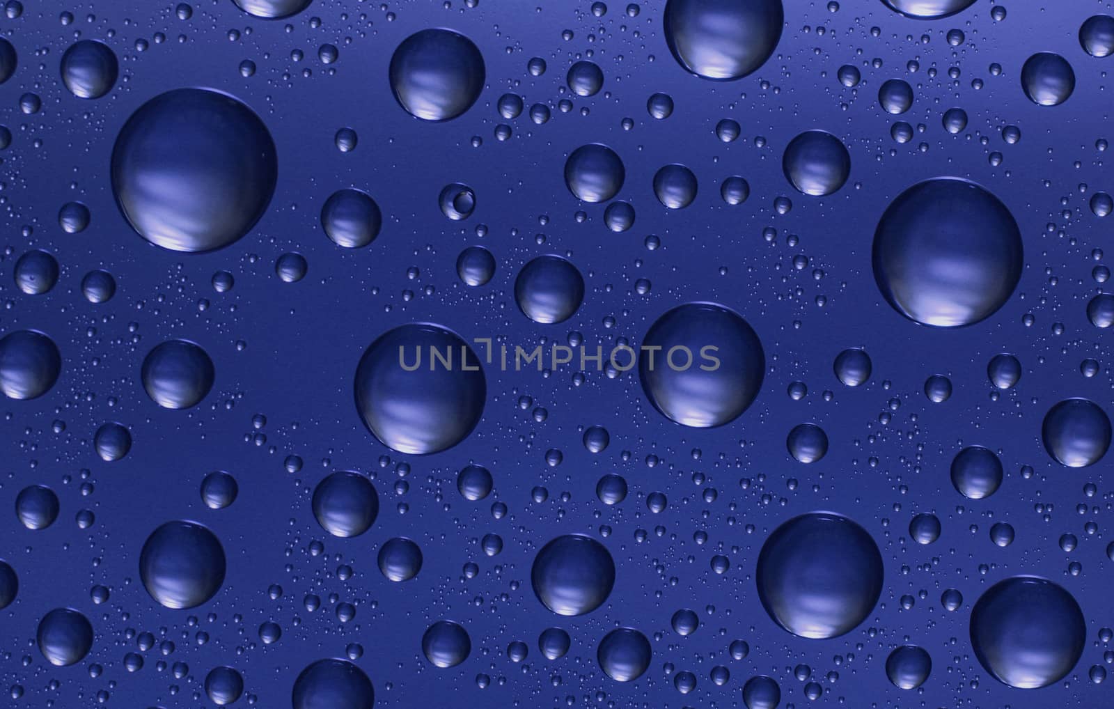 blue water drops on glass,could be used as background