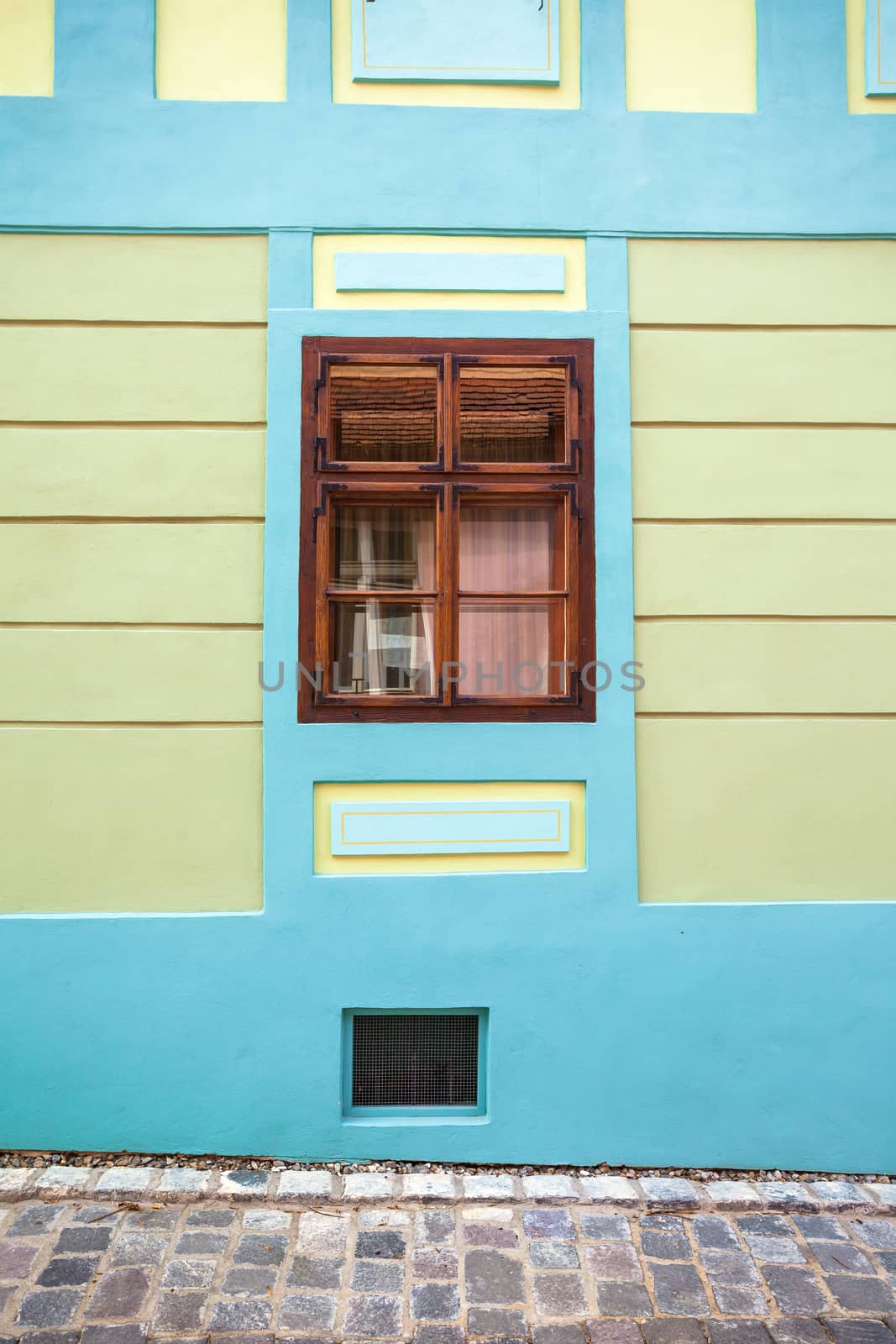 Sighisoara, Romania - June 23, 2013: Blue house facade with wooden window from Sighisoara city old center, Transylvania, Romania