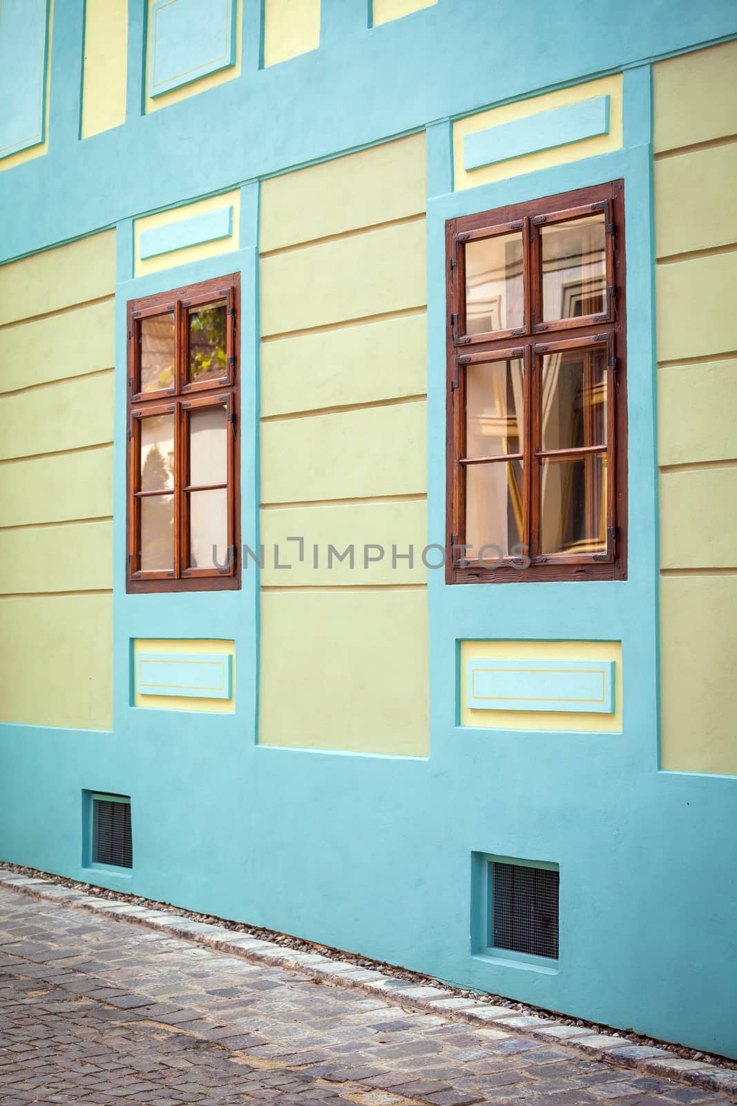 Sighisoara, Romania - June 23, 2013: Blue house facade with wooden windows from Sighisoara city old center, Transylvania, Romania